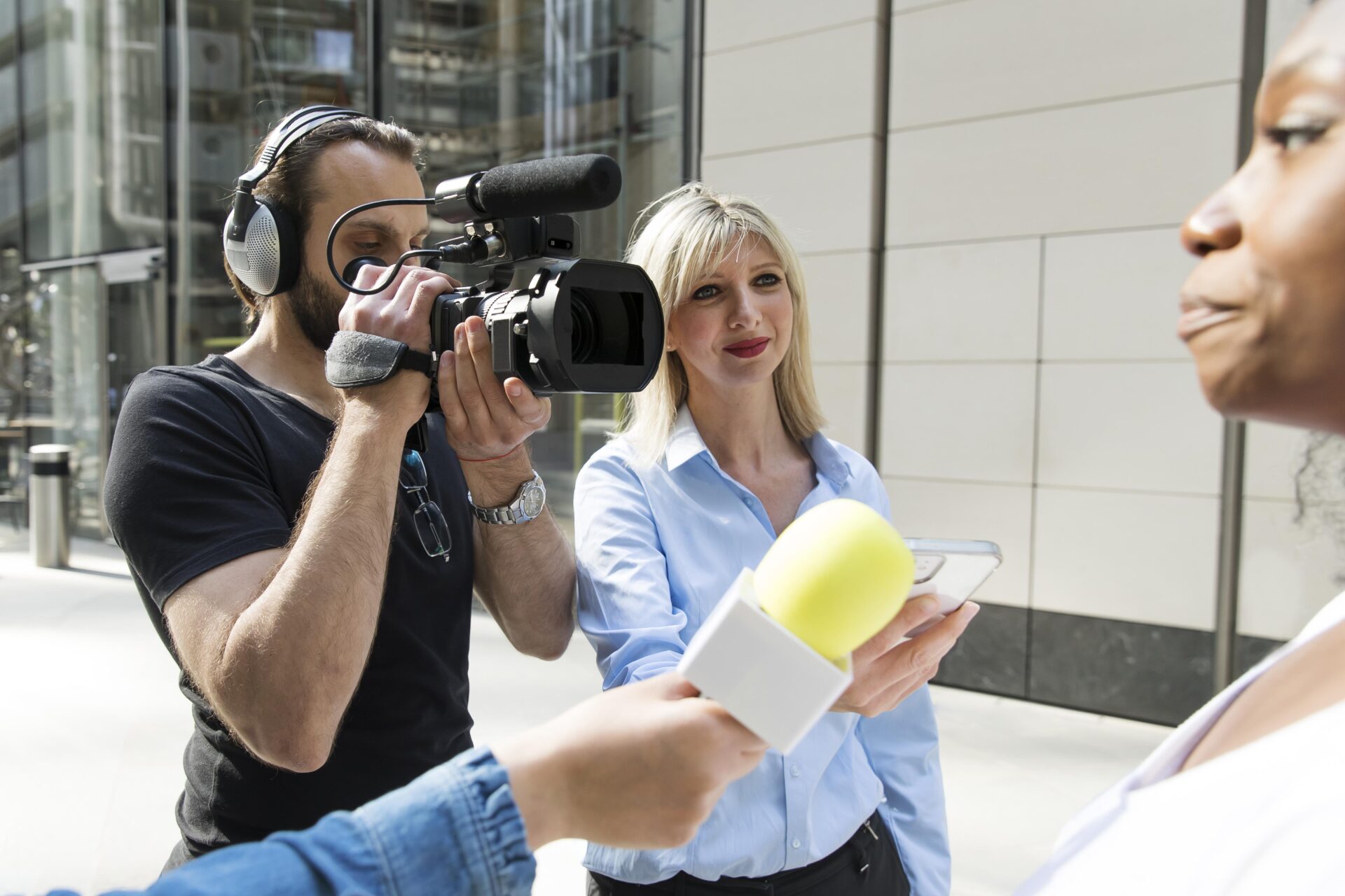 Close up on interviewee with microphone taking statements